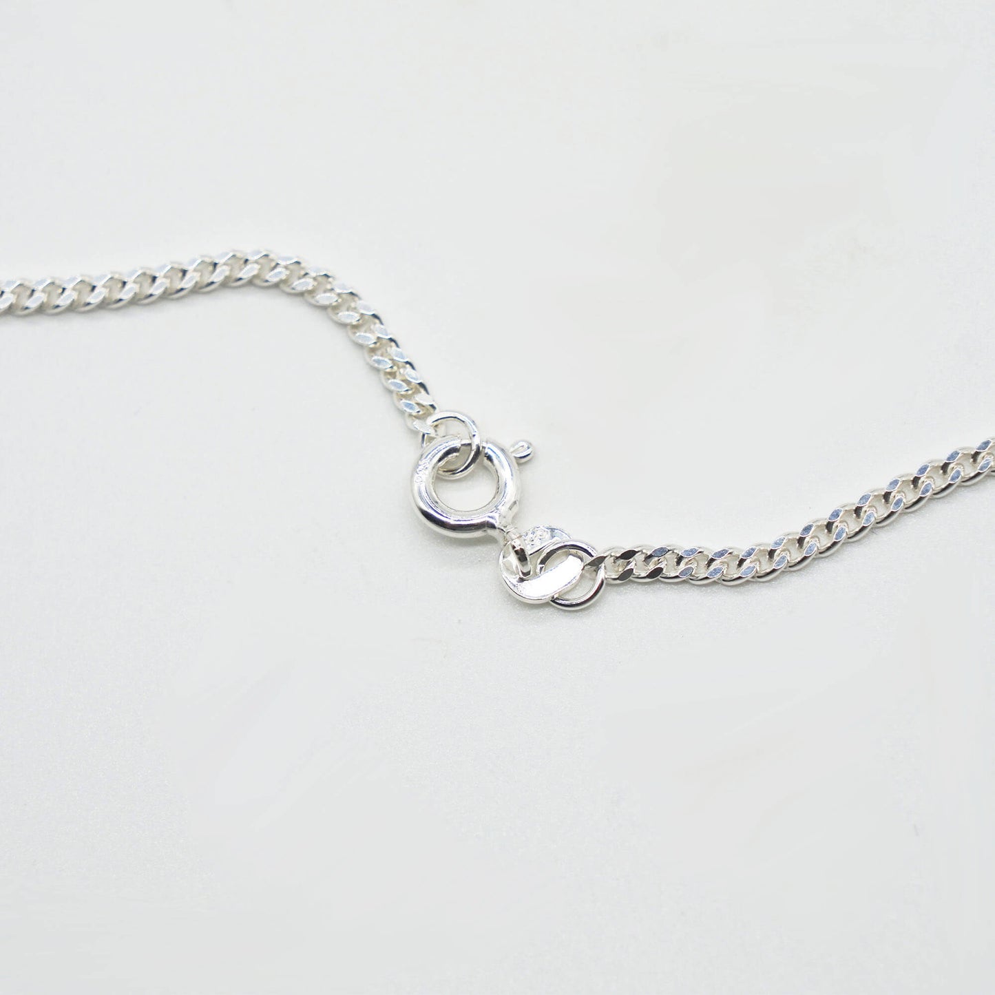 close up of sterling silver fine curb chain - with round lobster clasp.