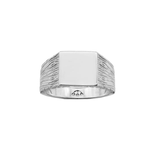 silver square smooth face signet ring, with bark textured shank and pawnshop balls logo on inner band.