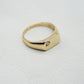 Side view of Vintage 9K gold smooth curved cz signet ring- hallmarks can be seen on inner band, white textured background.