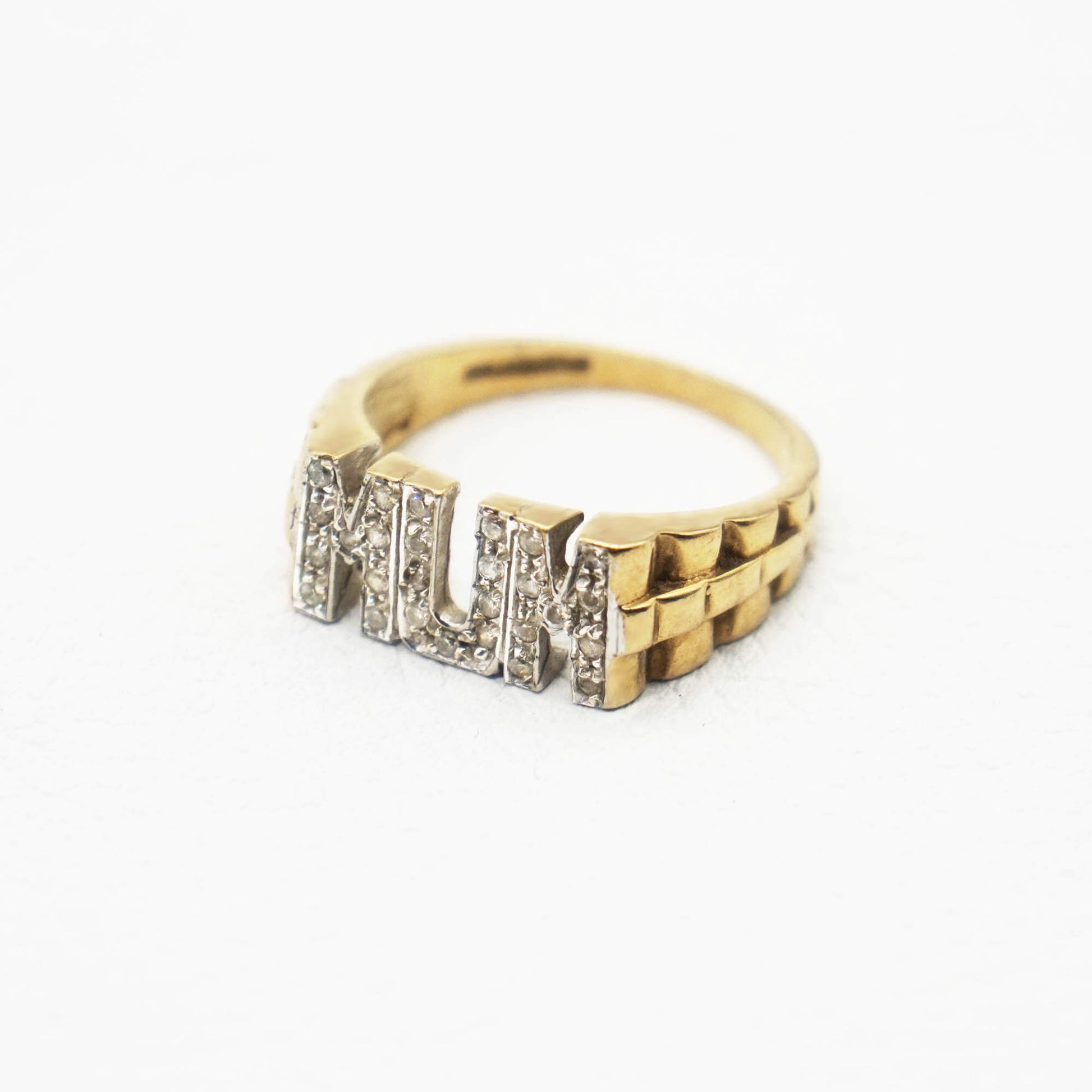 Side view showing textured band of Pave MUM ring