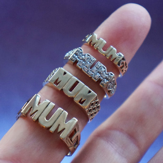 Close up 4 Vintage Mum Rings on a finger.