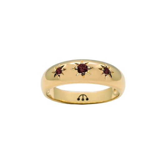 three garnet cubic zirconia stones set in a starburst setting in gold band ring.