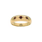three garnet cubic zirconia stones set in a starburst setting in gold band ring.