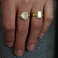 Close up mans hand wearing Vintage 9K gold 70s sunburst ring on middle finger, and vintage patterned ring on wedding finger.