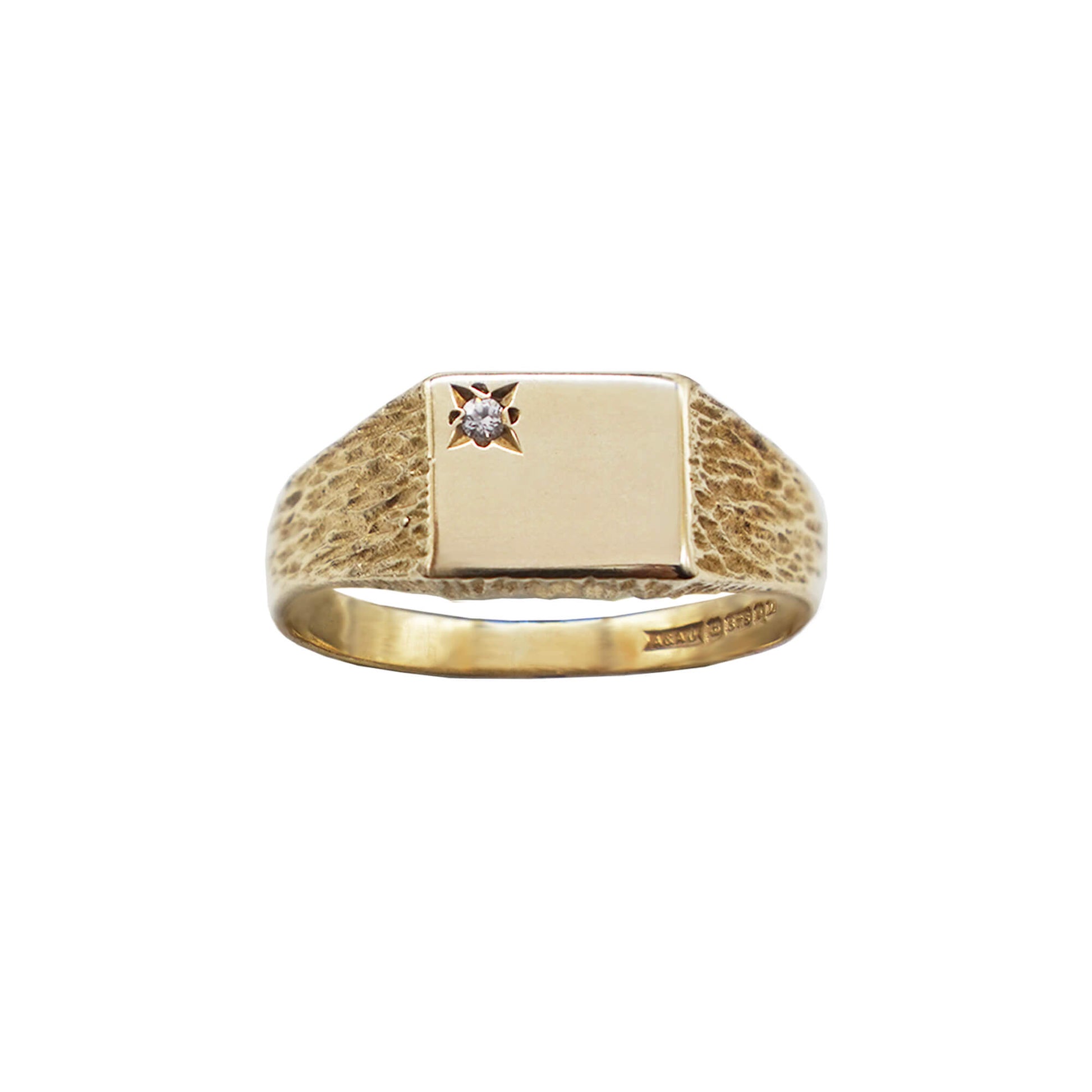  vintage 9k gold smooth rectangle face signet ring with corner starburst diamond stone, shank bark pattern, hallmarks visible on inner band.
