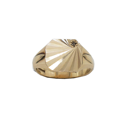 vintage gold signet ring with square faceted face and diamond starburst set in top right corner.